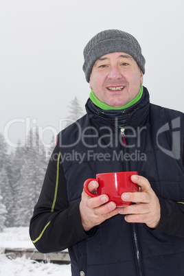 Man warms up a hot drink in the cup