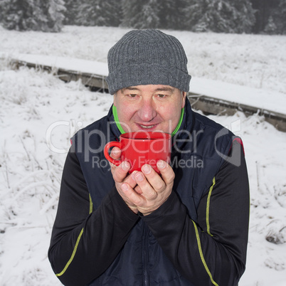 Man warms up a hot drink in the cup