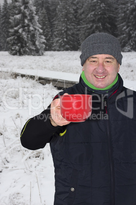 Man warms up a hot drink in the cup