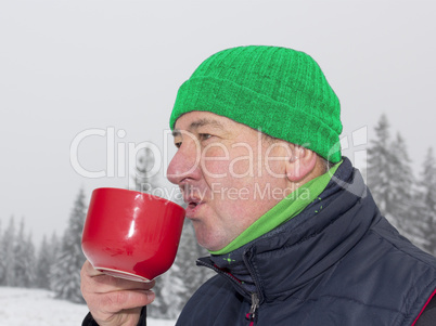 Man warms up a hot drink in the cup