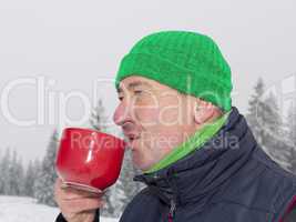 Man warms up a hot drink in the cup