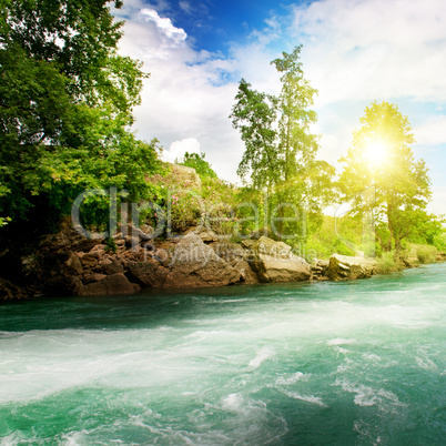 Sunrise, mountain river and the blue sky