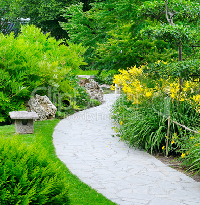 summer park with paths and flower beds