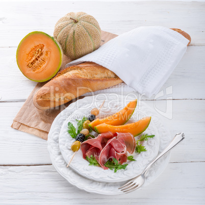Ham with melon and olives