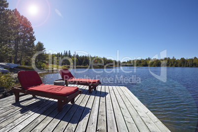 Wooden chairs overlooking a lake