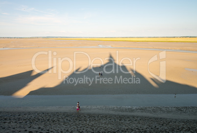 Shadow of Mont Saint Michel Abbey on the beach - France