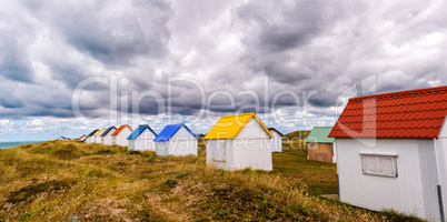 Multicolour huts over the ocean. Beautiful countryside landscape