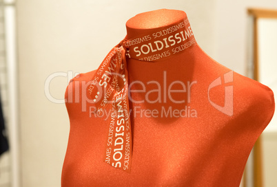 Manikin with red scarf. Sale abstract concept