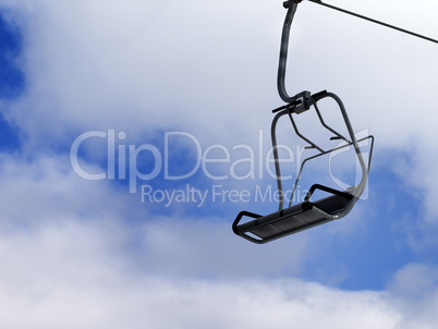 Chair-lift and blue sky with clouds