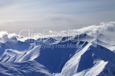 Evening snowy mountains in mist