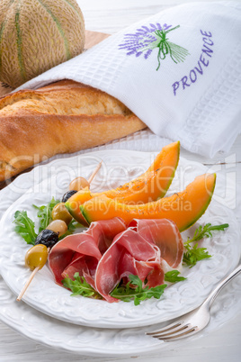 Ham with melon and olives