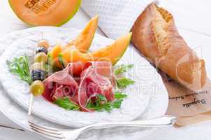 Ham with melon and olives