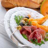 Ham with melon and olives