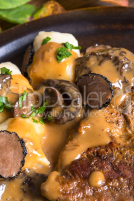 Steak with potato dumplings and forest mushroom sauce