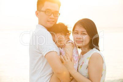 Asian family enjoying sunset beach
