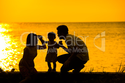 Asian family outdoor sunset beach