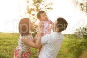 Asian family playing at park