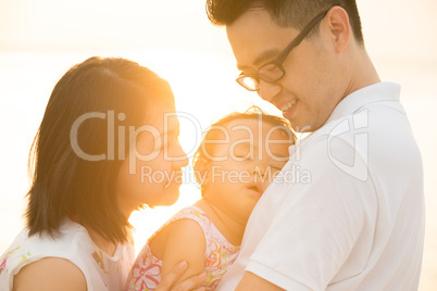 Asian family at outdoor sunset beach