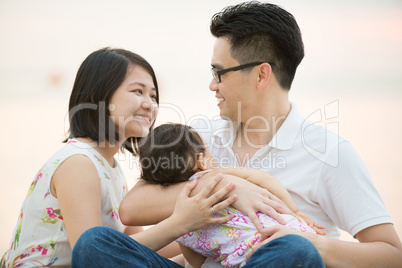 Happy Asian family at outdoor beach