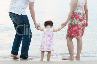 Happy Asian family at outdoor sand beach