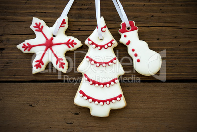 Christmas Cookies Hanging on Wood Closeup