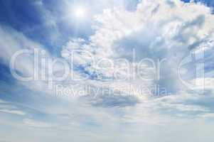 sun on blue sky with white clouds