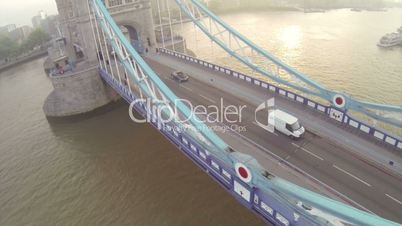 Camera flying above London bridge over Thames river