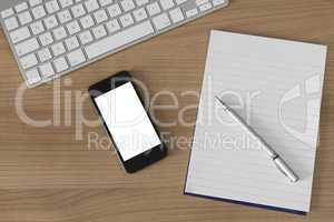 Wooden desk keyboard smartphone and notepad