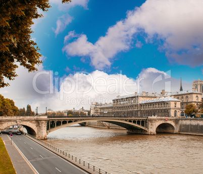 Notre Dame Bridge in Paris with Seine river and city traffic