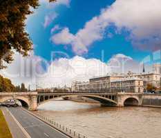 Notre Dame Bridge in Paris with Seine river and city traffic
