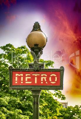 Paris, France. Classic Metro symbol. Subway sign with trees in b