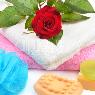 Towels, soap and sponges isolated on white background