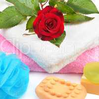 Towels, soap and sponges isolated on white background