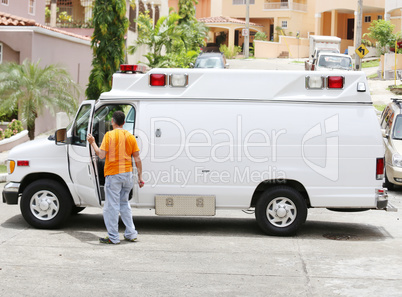 White ambulance with the driver getting out to help the paramedi