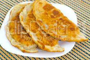Chebureks on the table on a white plate