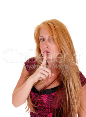 Woman with finger on mouth.