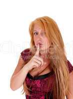 Woman with finger on mouth.
