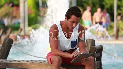 attractive young men using digital tablet