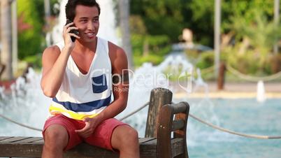 attractive young handsome boy talking smartphone