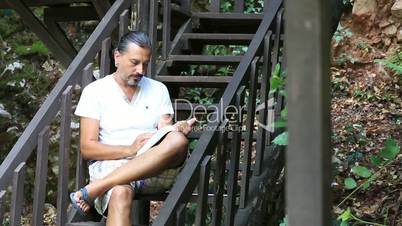 middle age brunette man reading a book