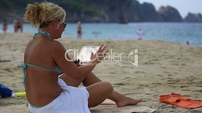 attractive blonde women using digital tablet