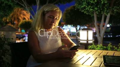 attractive blonde women using smartphone