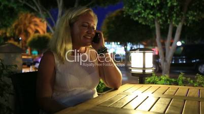 attractive blonde women talking smartphone