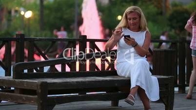 attractive blonde women talking smartphone