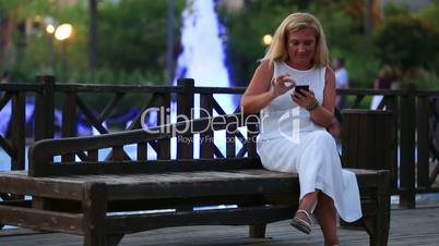 attractive blonde women using smartphone