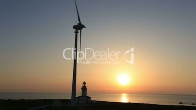 wind turbines generating clean power with lighthouse