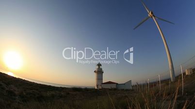 wind turbines generating clean power with lighthouse