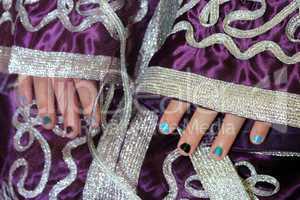 girl's hands in Moroccan suit