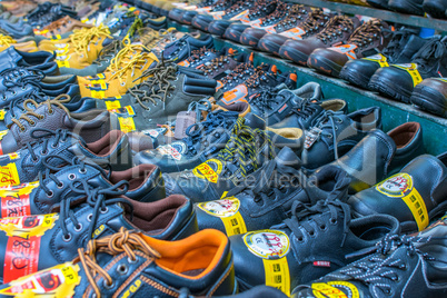 HONG KONG, APRIL 10: Market sale of shoes on the sidewalk road i