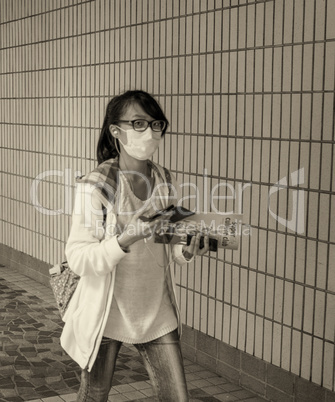 HONG KONG - MAY 12, 2014: Unidentified girl wearing a mask on th
